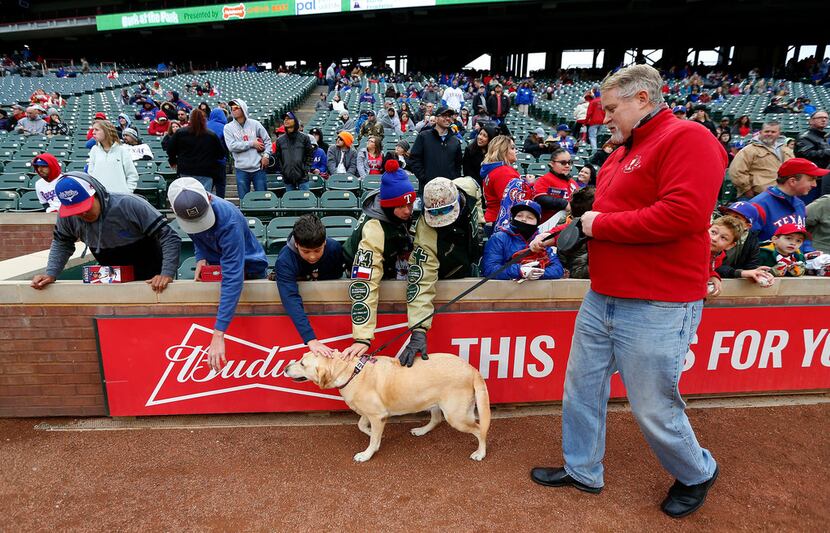 Rangers fan Bill Mahoney walks on the ground with his dog Delilah, 7, during the annual Bark...