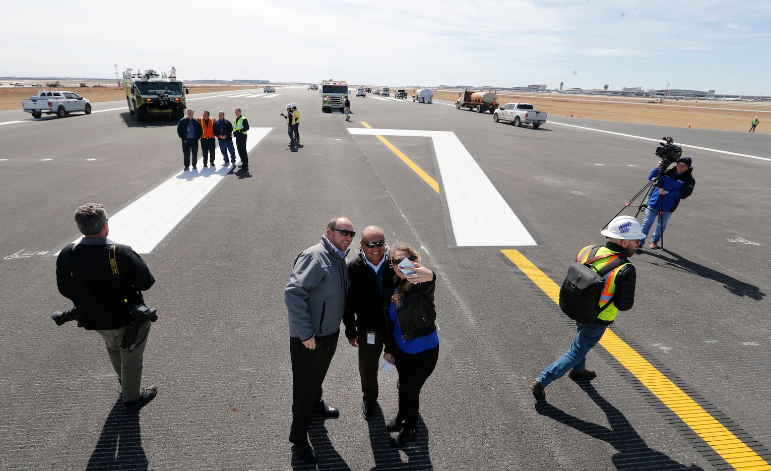 DFW International Airport employees William Grozdanich (group at center, from left), Robert...