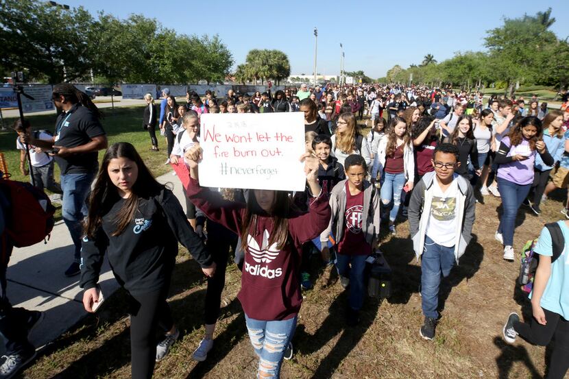 Students from Westglades middle school next to Marjory Stoneman Douglas High School join the...