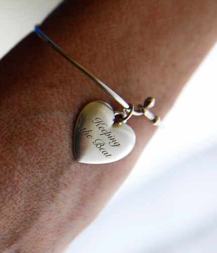 Andie Kay Joyner wears a heart bracelet that says "keeping the beat." She's a musician who...
