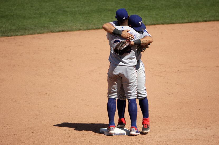 Texas Rangers shortstop Danny Santana (38) and second baseman Rougned Odor hug after their...