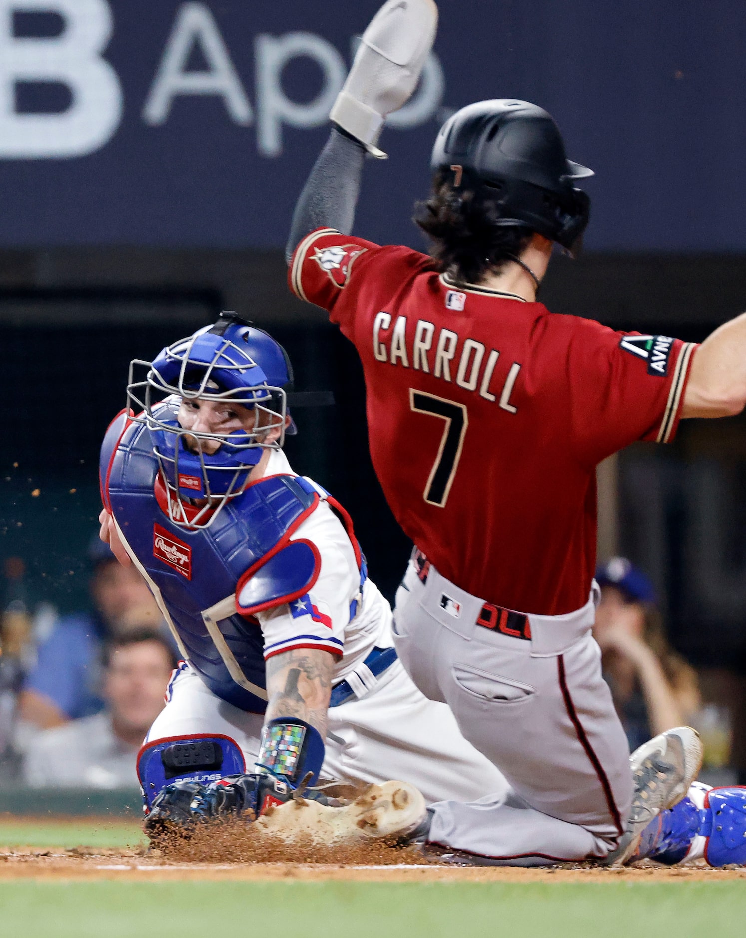 Texas Rangers catcher Jonah Heim (28) is late in getting the tag on Arizona Diamondbacks...