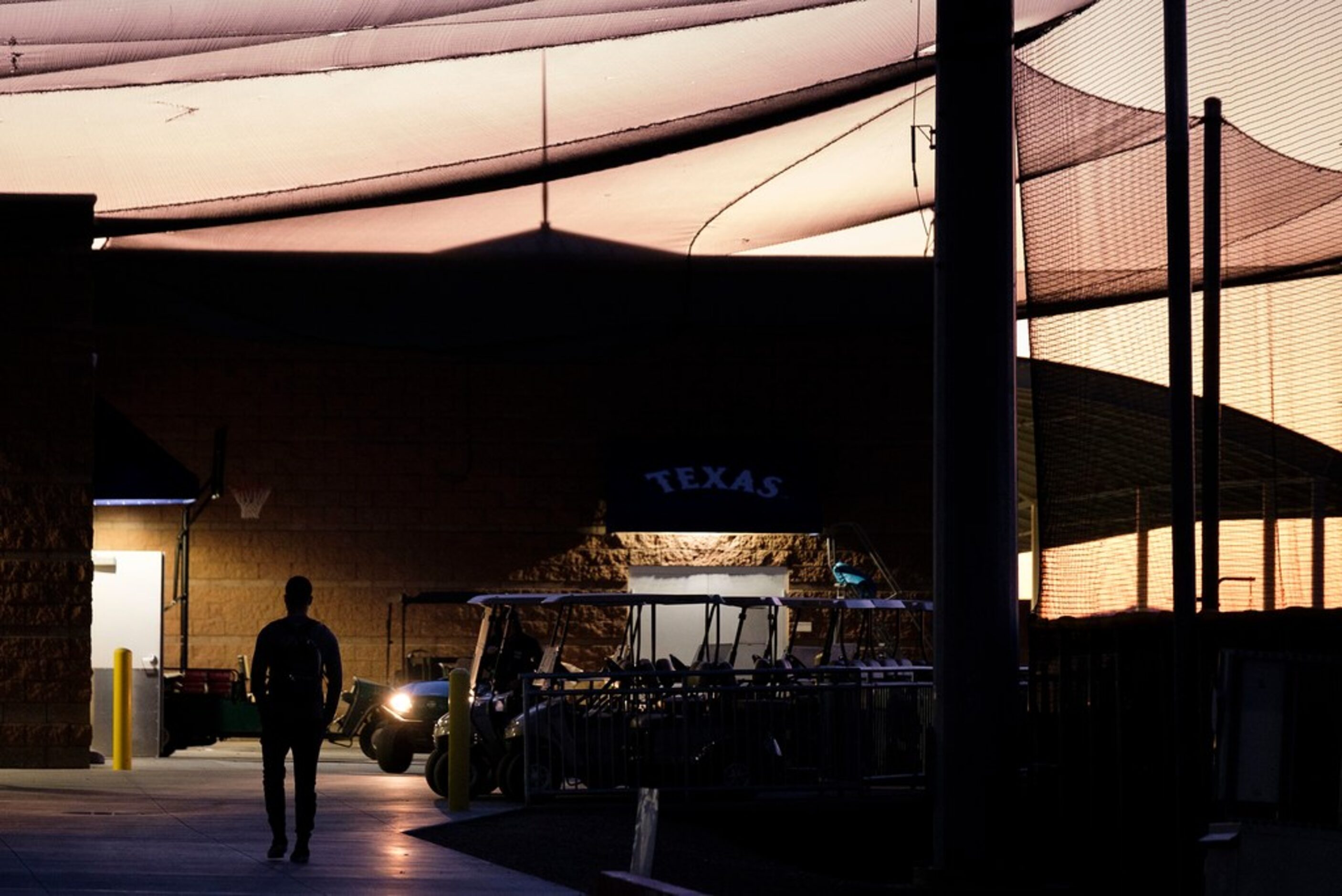 Texas Rangers catcher Isiah Kiner-Falefa heads toward the clubhouse before sunrise as...