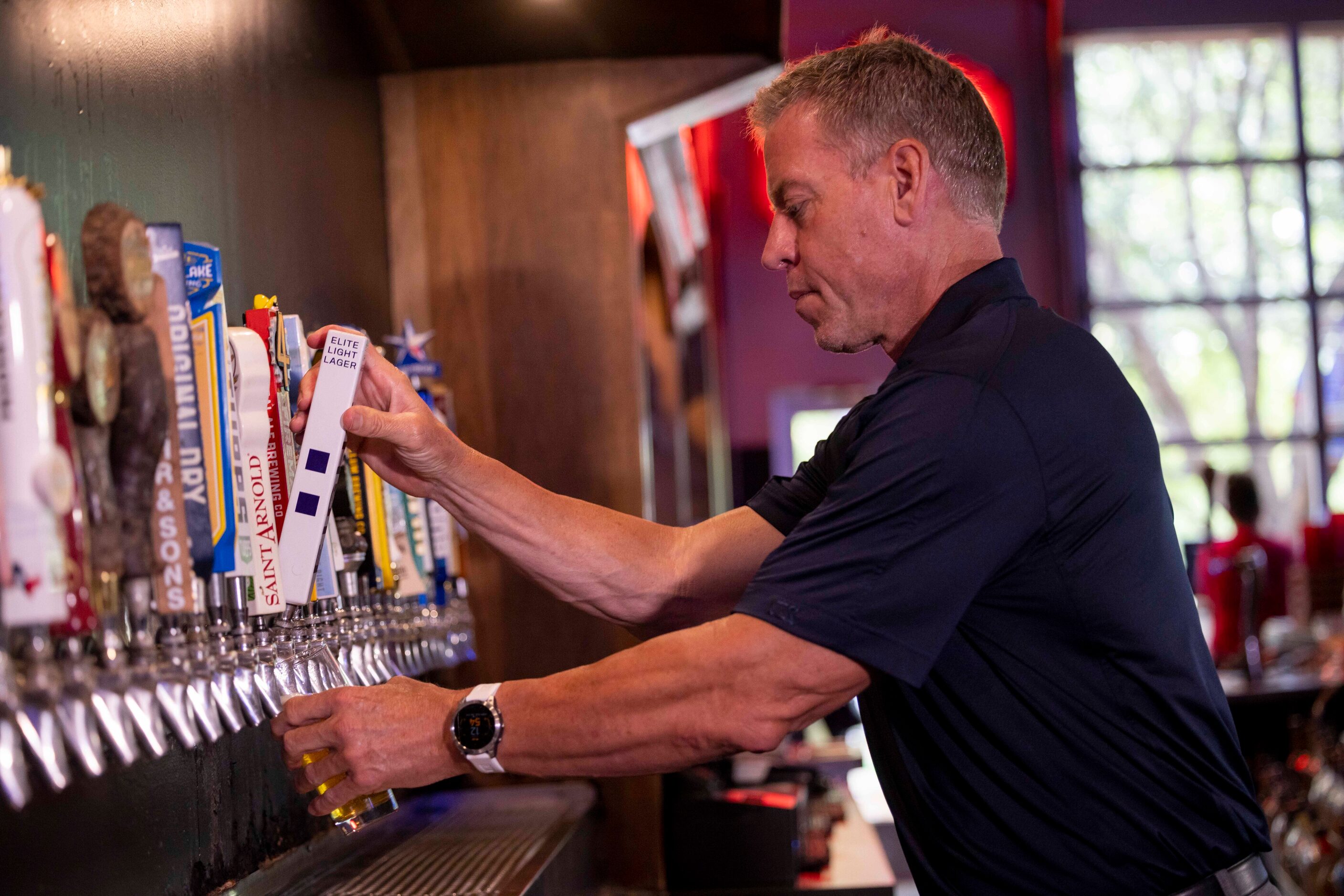 Former Cowboys quarterback Troy Aikman pours his beer EIGHT from the tap at Katy Trail Ice...