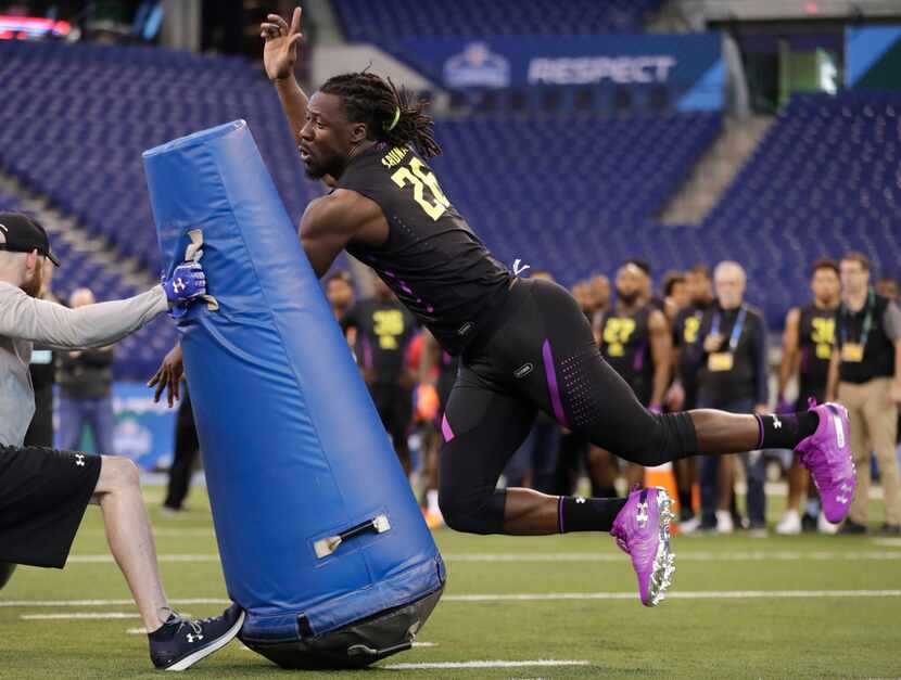 Tulane defensive lineman Ade Aruna runs a drill at the NFL football scouting combine in...