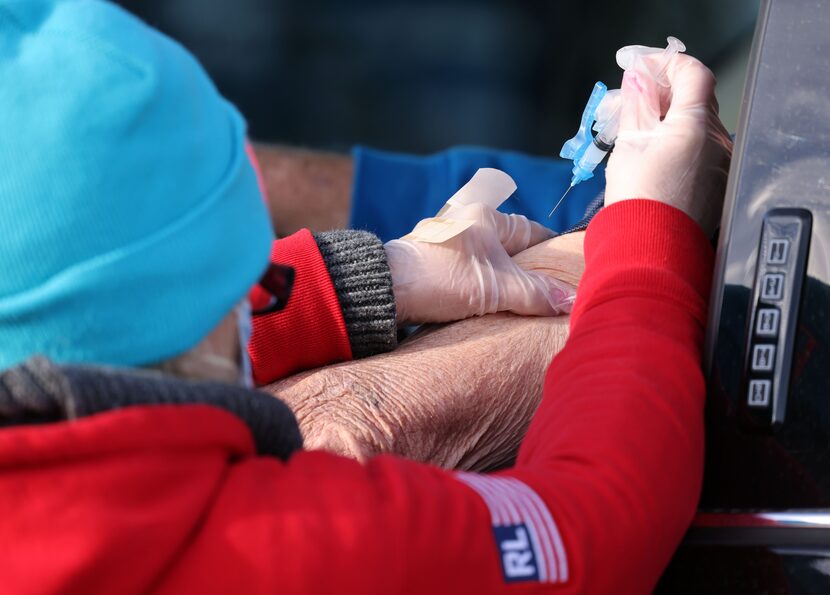 Nurse Penny Mayo administers a COVID-19 vaccination clinic at Texas Motor Speedway.