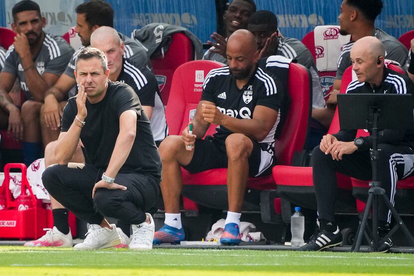 FC Dallas head coach Nico Estévez (kneeling) watches from the bench during the first half of...