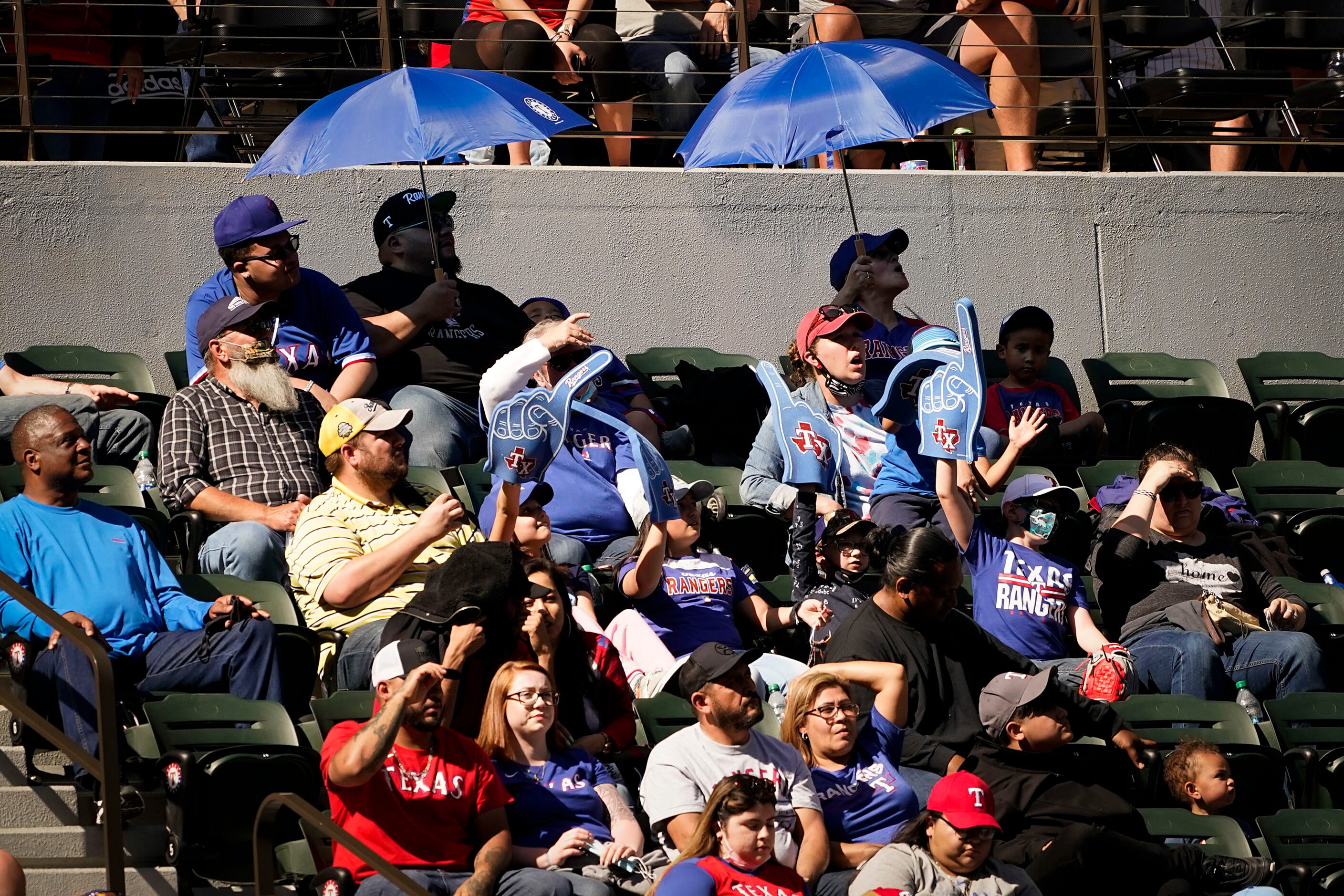 Texas Rangers fans cheer their team during the tenth inning of the Rangers 1-0 walk-off...