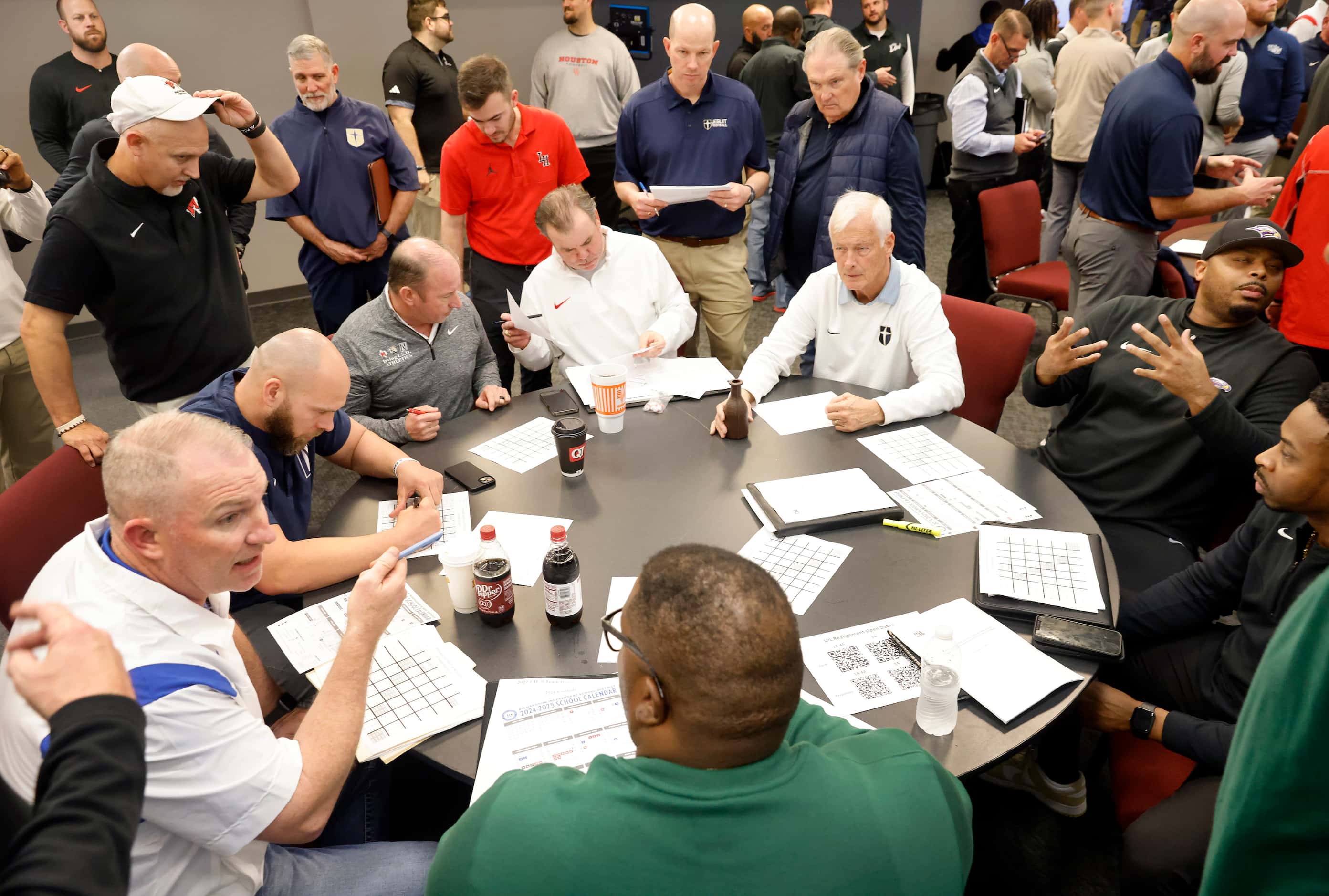 Football coaches from 6A-District 7 draw numbers to create this years football schedule...