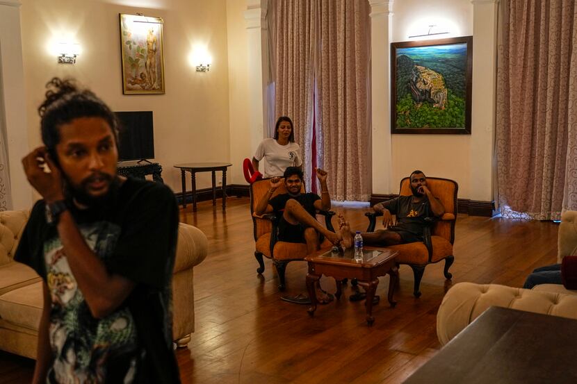 Protesters sit on sofa inside the official residence of president Gotabaya Rajapaksa fourth...