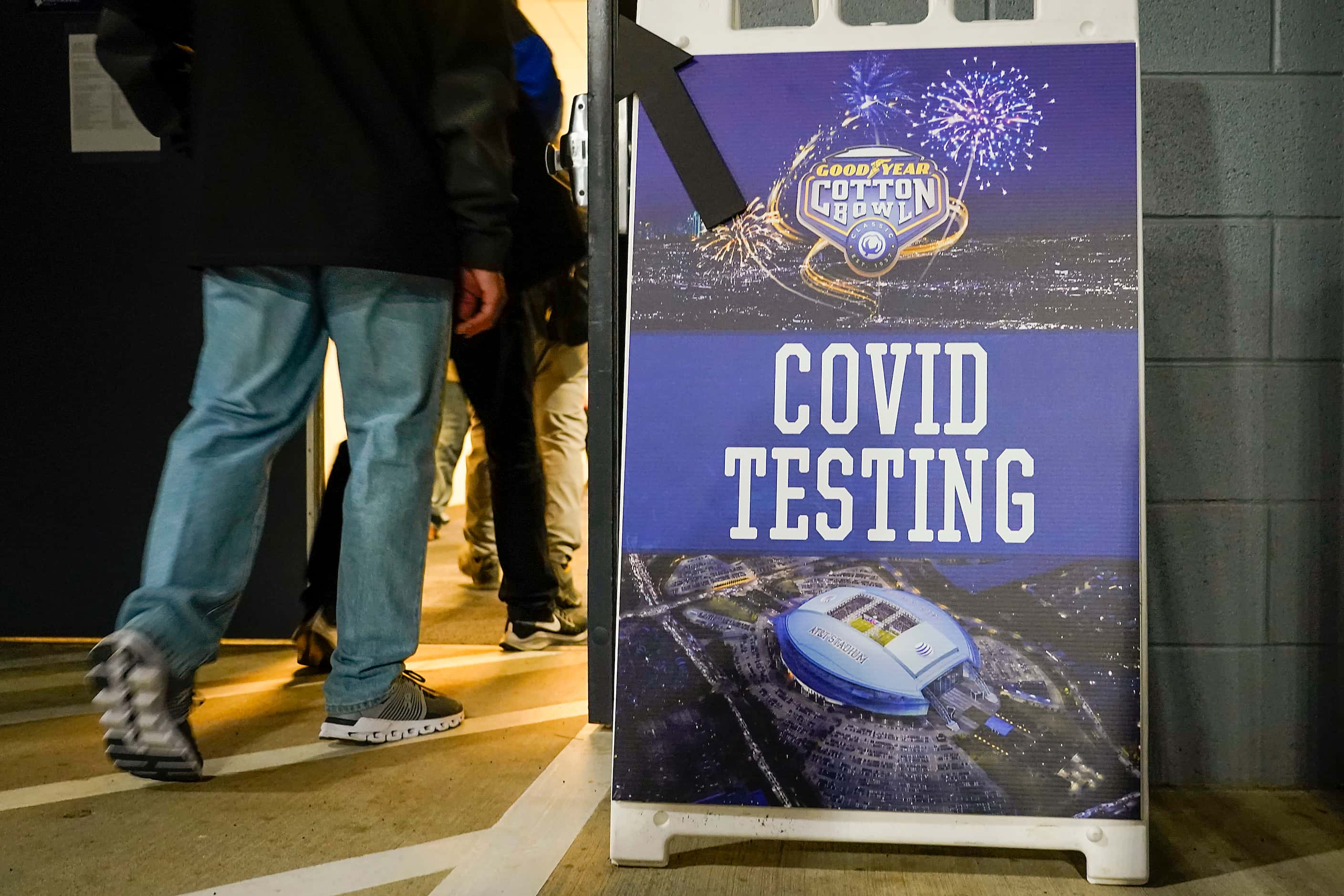 Signs direct field level workers and media to COVID-9 testing before the Cotton Bowl Classic...