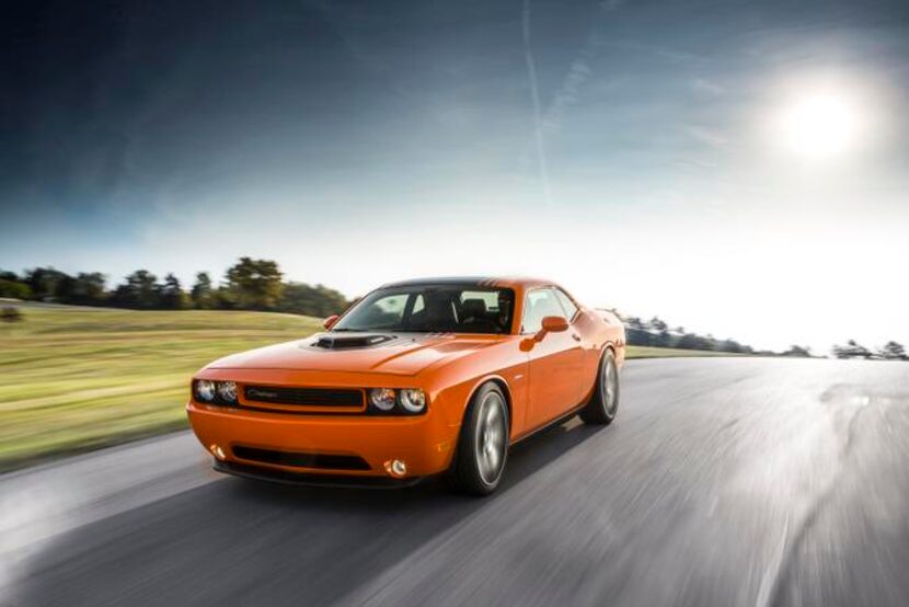 
The 2014 Dodge Challenger R/T Shaker’s long hood abuts big fenders that flow into large,...