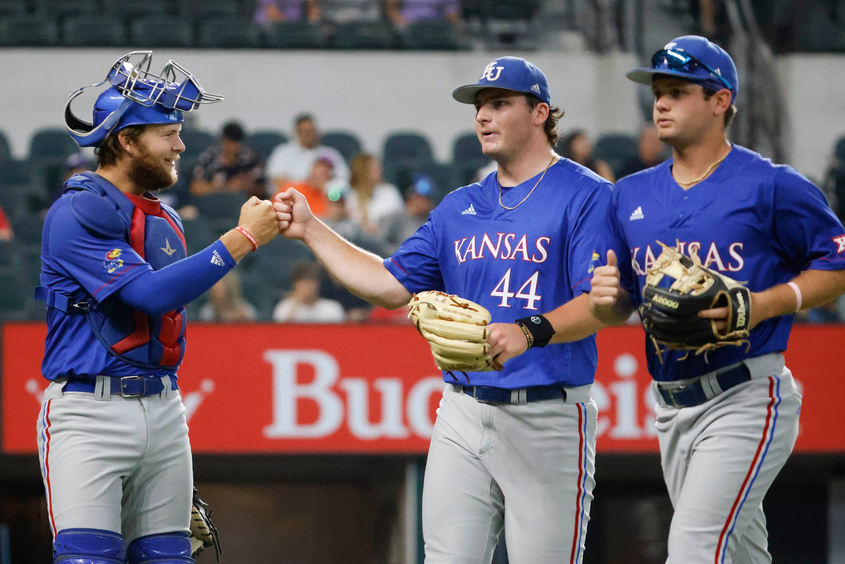 Kansas catcher Jake English (left) cheers with Kansas pitcher Sam Ireland during inning...