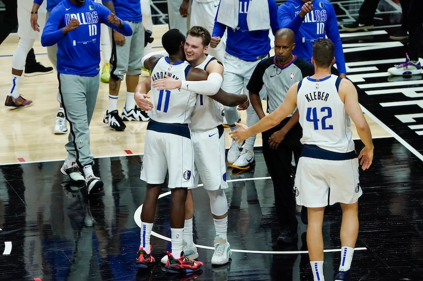 Dallas Mavericks guard Luka Doncic celebrates with forward Tim Hardaway Jr. (11) after the...