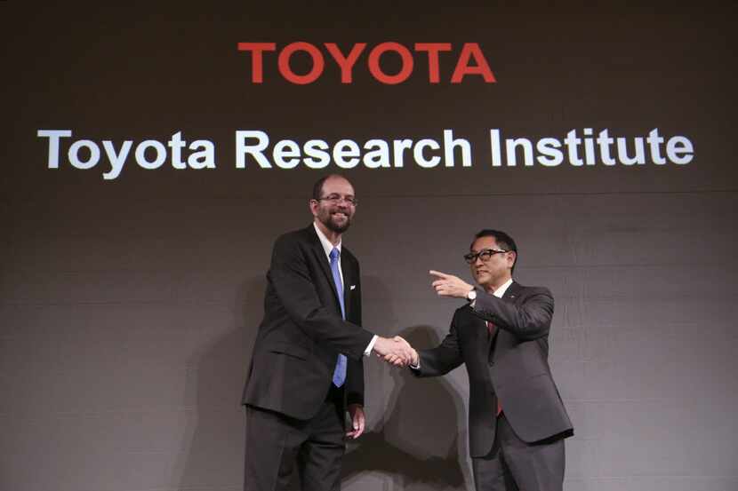 Toyota Motor Corp.'s Executive Technical Advisor Gill Pratt, left, and President Akio...