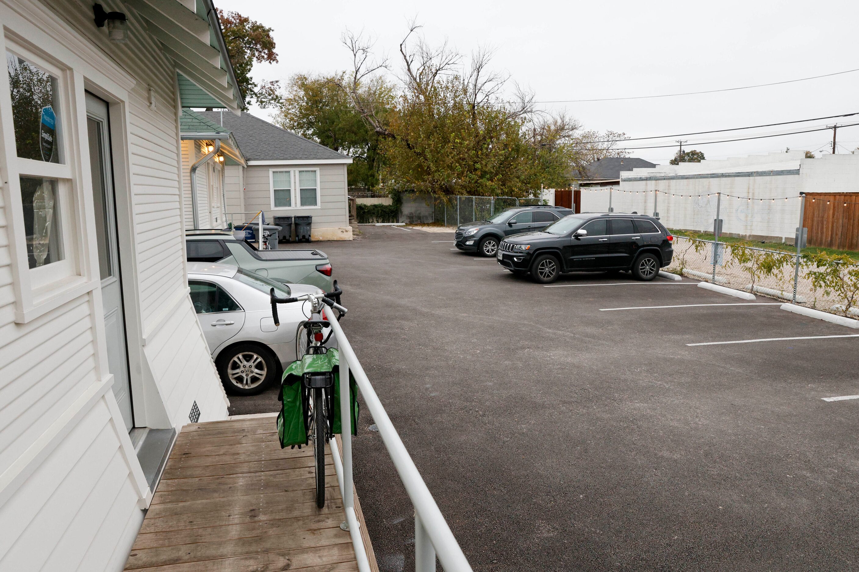 Several parking spots are seen behind two remodeled houses that are now a collection of...