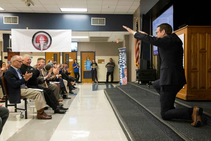 Texas education commissioner Mike Morath bows toward the Back Elementary staff on Monday,...