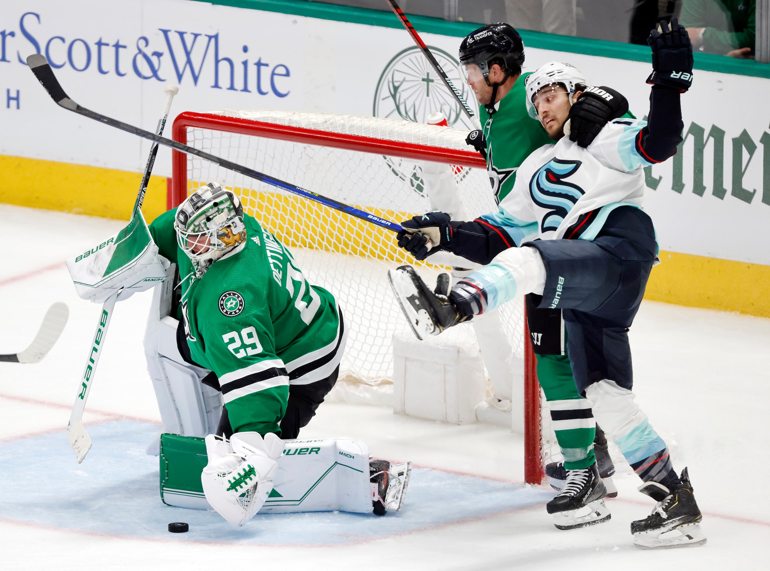 Dallas Stars defenseman Ryan Suter (20) wrangles Seattle Kraken left wing Brandon Tanev (13)...