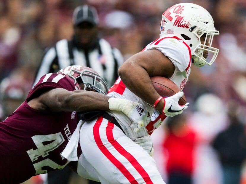 Texas A&M Aggies linebacker Otaro Alaka (42) tackles Ole Miss Landsharks running back...