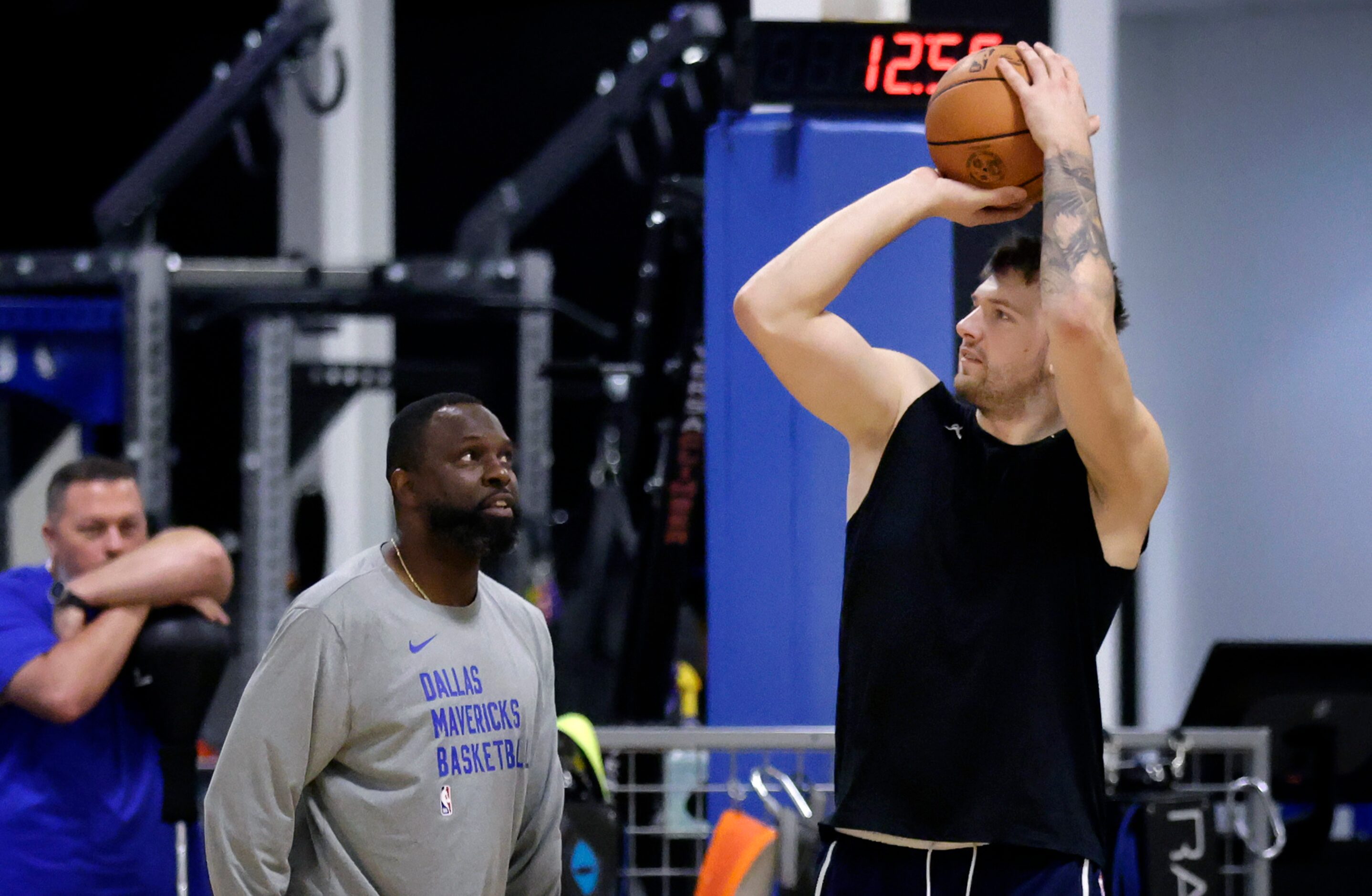 Dallas Mavericks guard Luka Doncic shoots 3-pointers during practice at their practice...