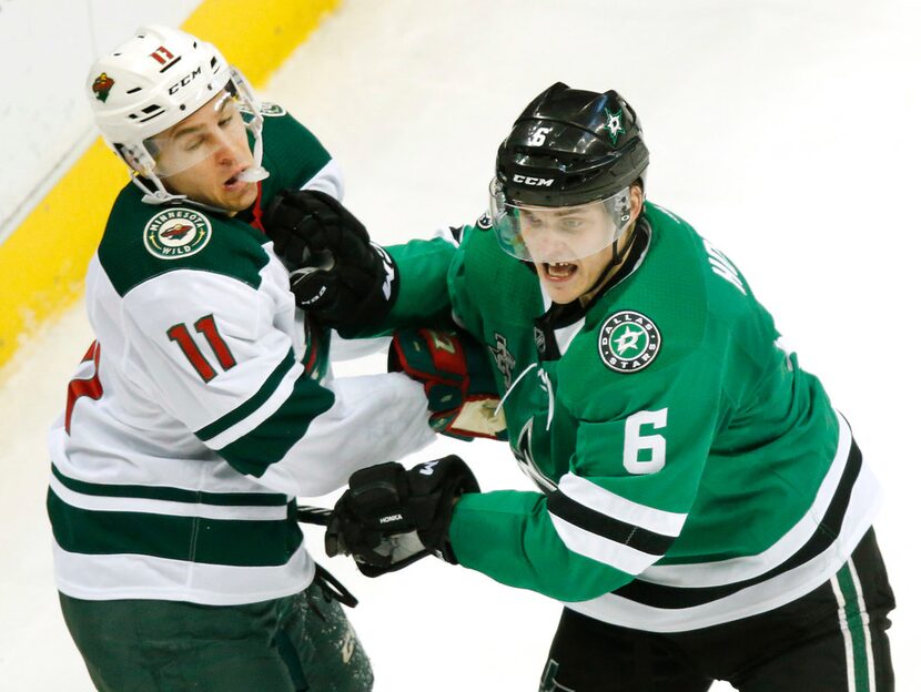 Dallas Stars defenseman Julius Honka (6) gives Minnesota Wild left wing Zach Parise (11) a...