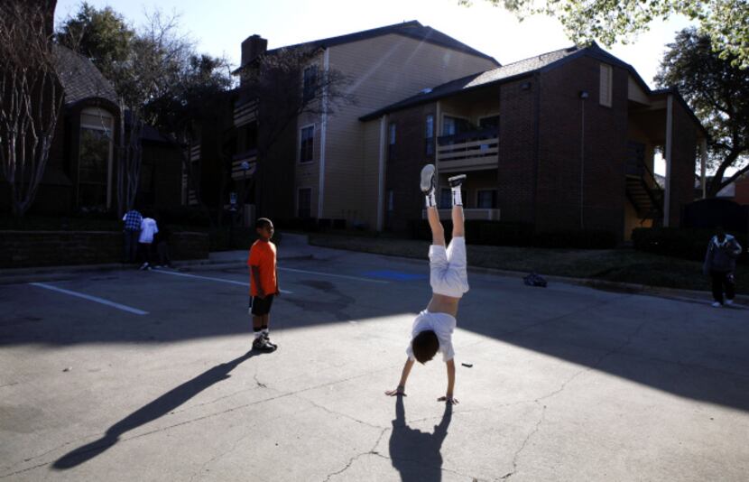 Jaylen Moore watches Austin Collins do a handstand at the Champions of North Dallas...