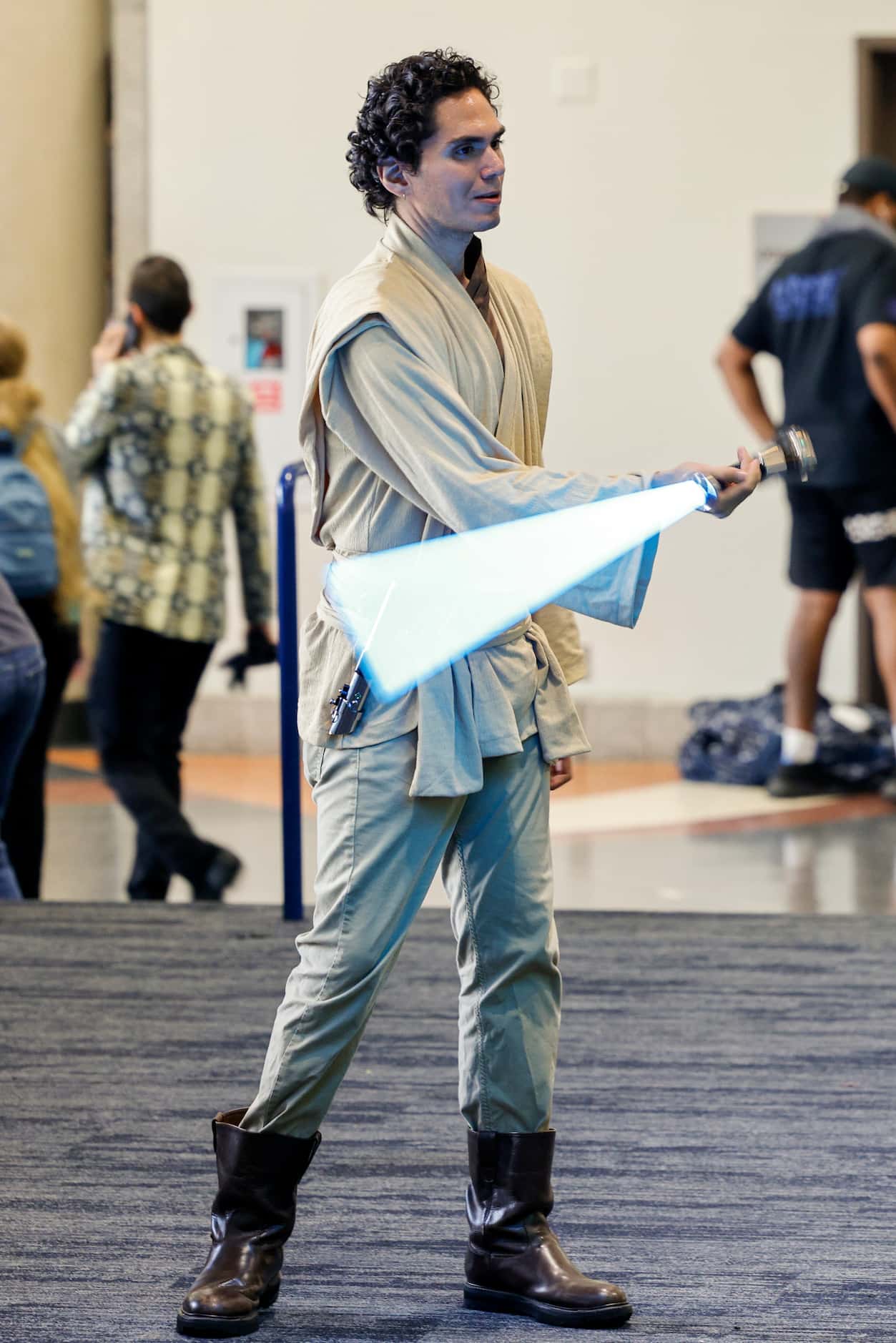 Christopher Perez of Dallas spins a lightsaber at Fan Expo Dallas at the Kay Bailey...