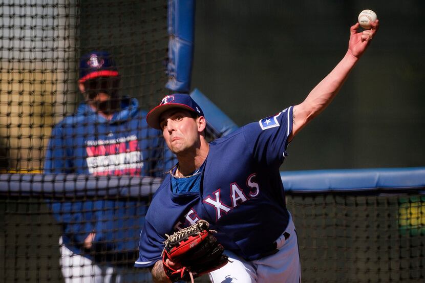 Texas Rangers pitcher Joe Palumbo throws live batting practice during a spring training...