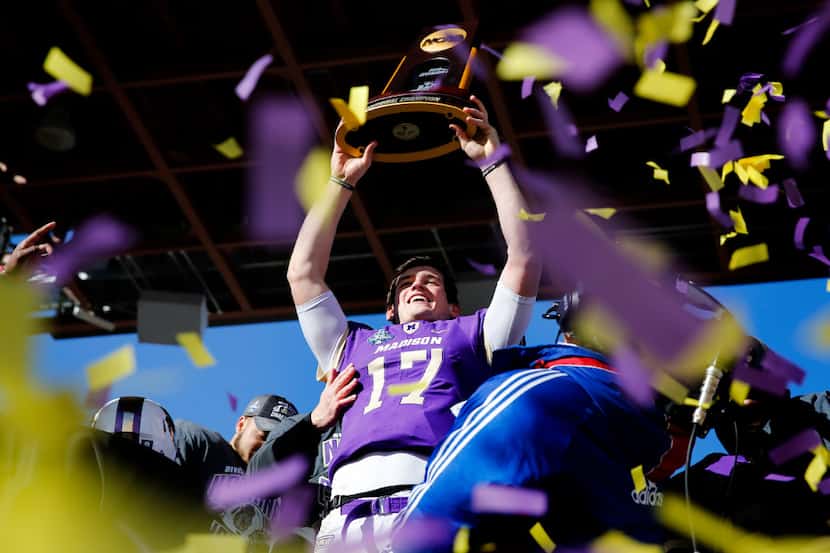 James Madison Dukes quarterback Bryan Schor (17) holds up the championship trophy after a...