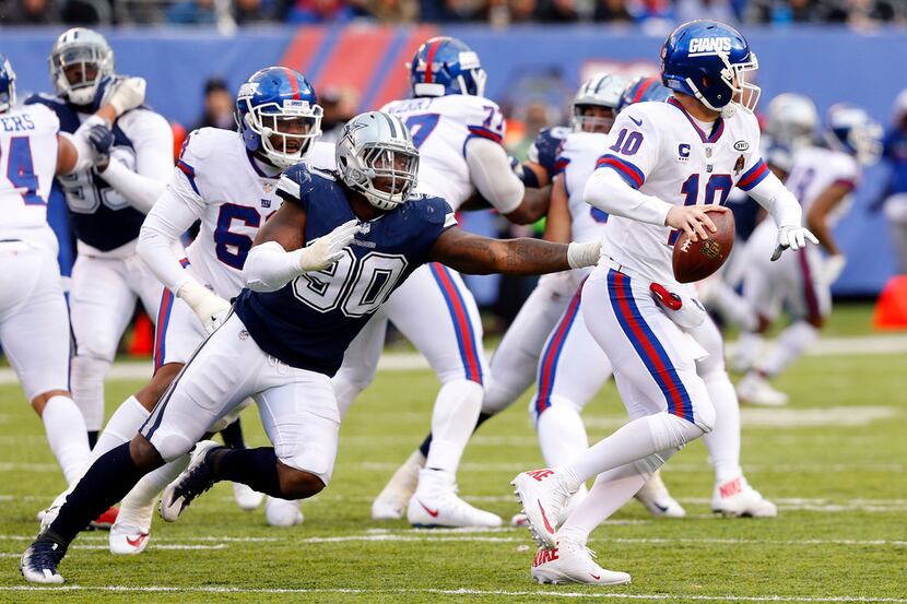 Dallas Cowboys defensive end Demarcus Lawrence (90) chases down New York Giants quarterback...