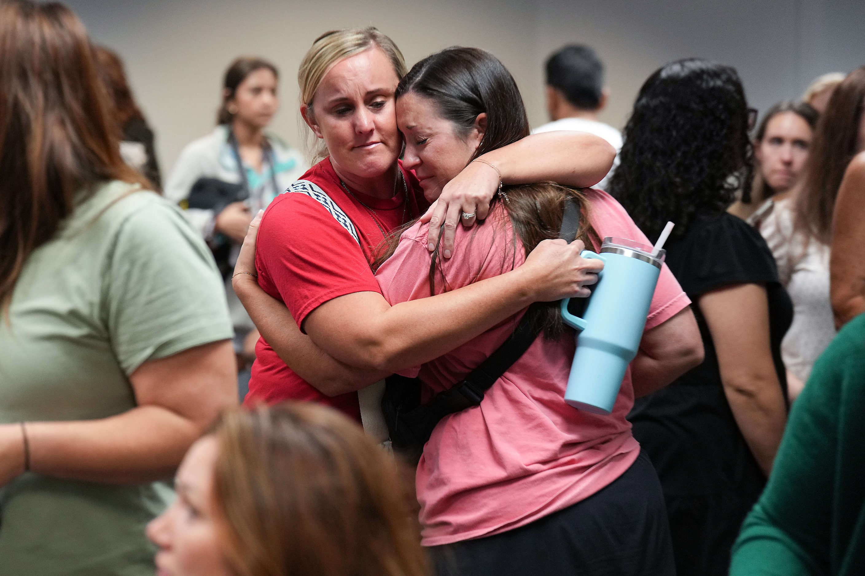 People in the audience react after a vote to close Pinkerton Elementary School during the...