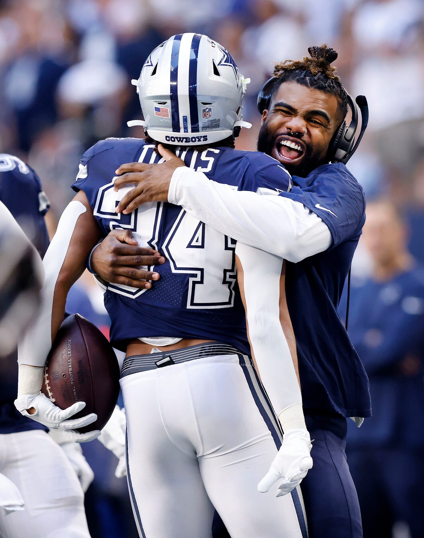 Injured Dallas Cowboys running back Ezekiel Elliott (right) hugs fellow running back Malik...