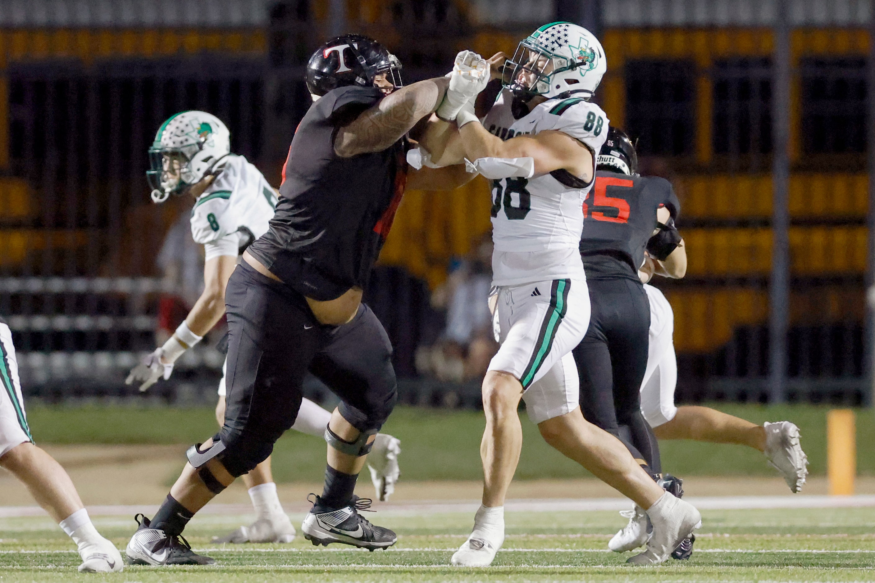 Euless Trinity offensive lineman Pupungatoa Katoa (76) blocks Southlake Carroll tight end...