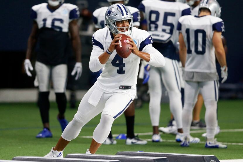 Dallas Cowboys quarterback Dak Prescott (4) runs through a drill at practice during training...