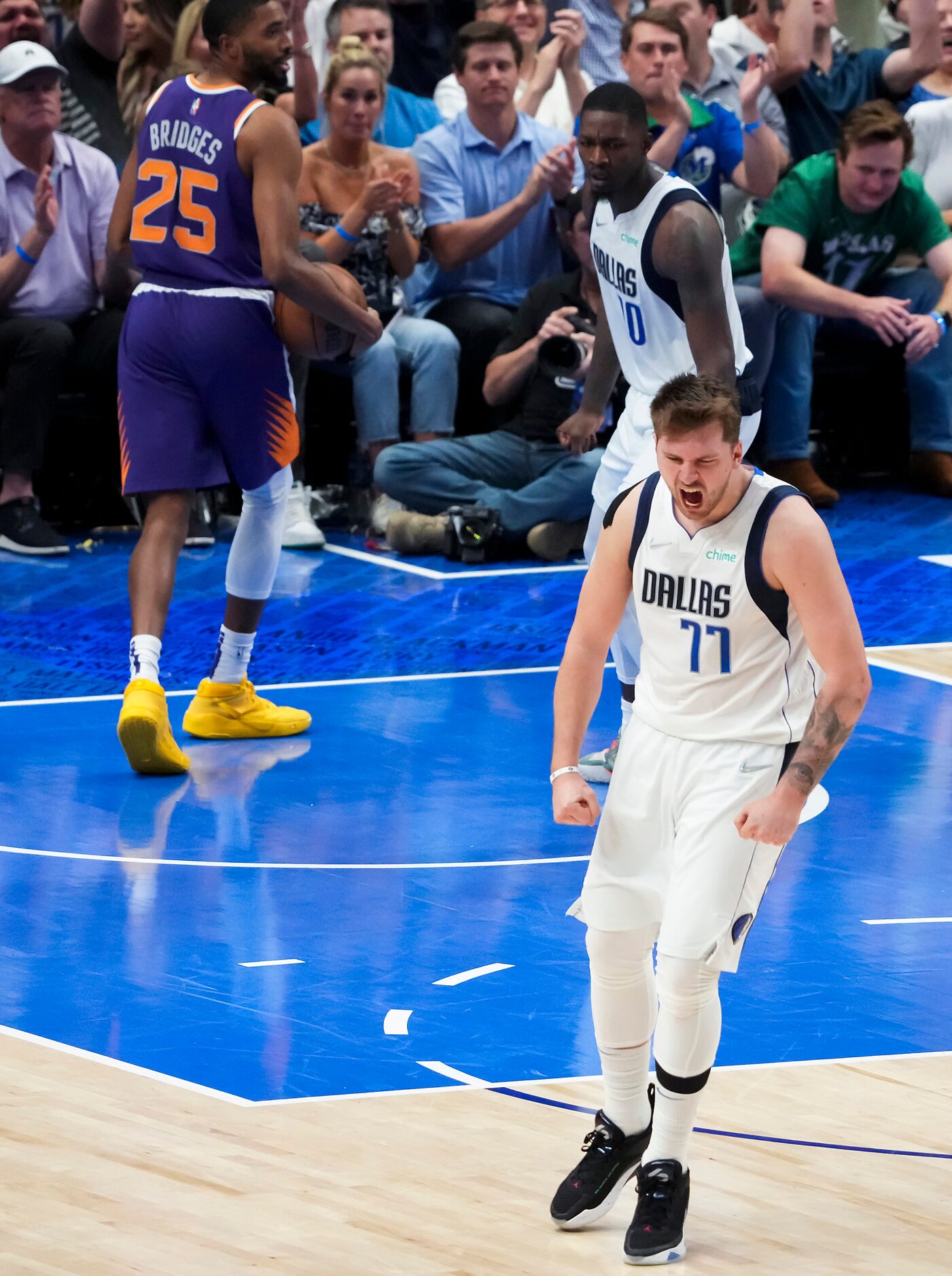 Dallas Mavericks guard Luka Doncic (77) celebrates after scoring past Phoenix Suns forward...