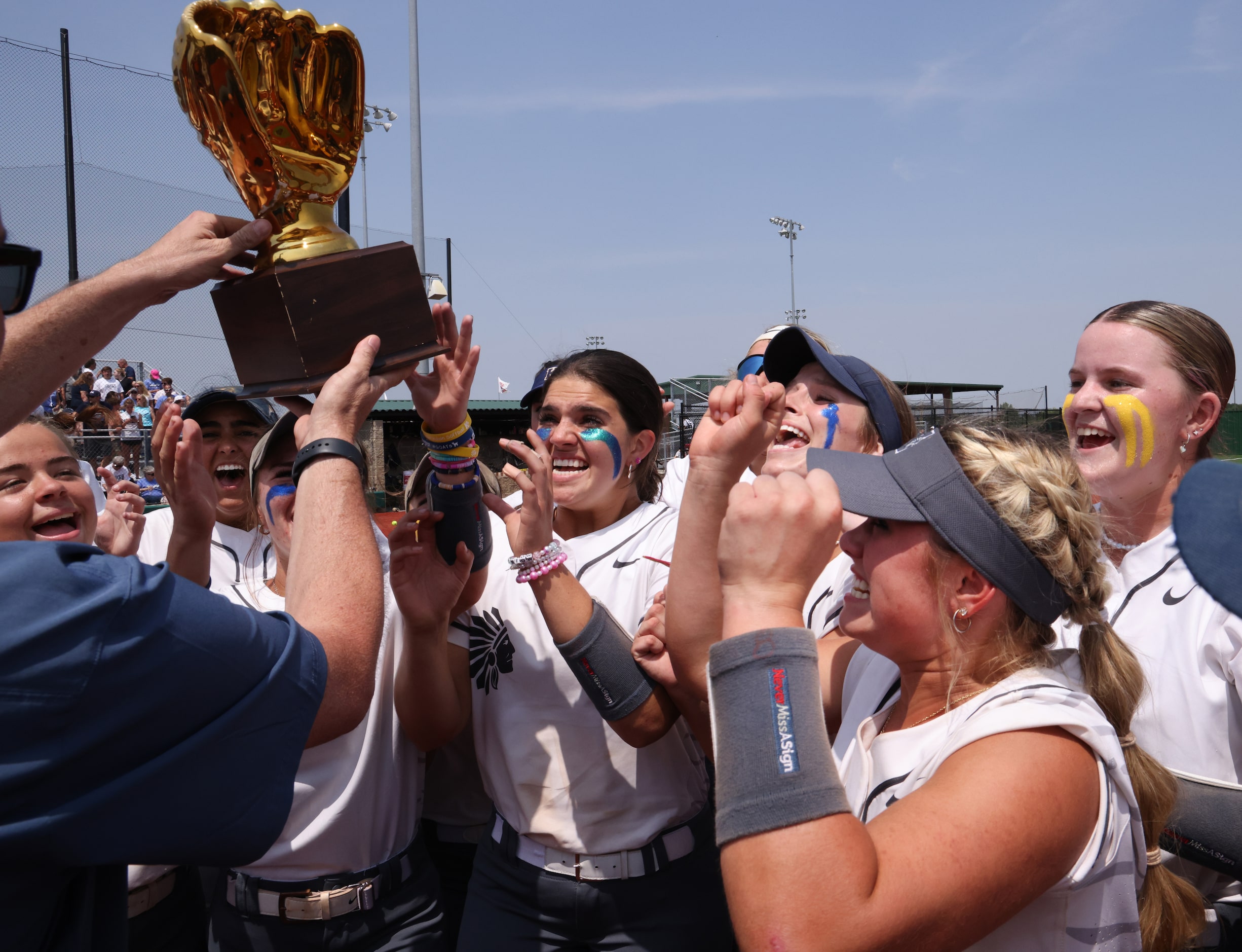 Keller players react in celebration of their trophy presentation after winning Game 3 of...