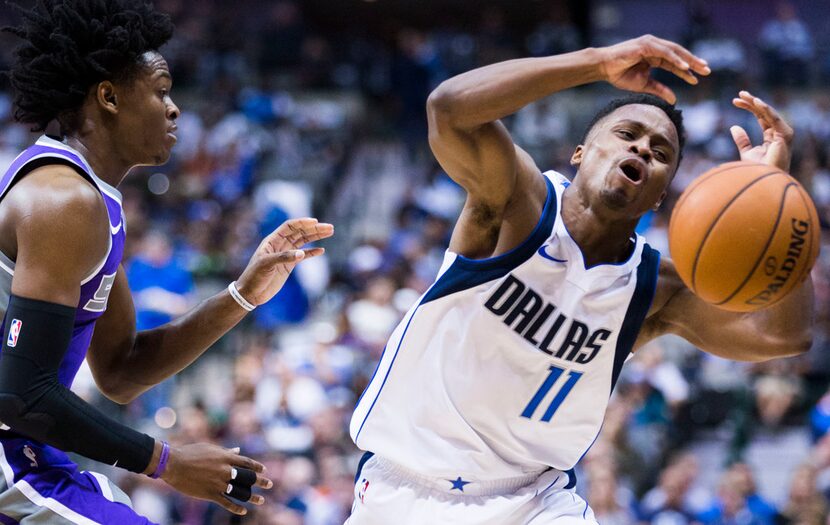 Dallas Mavericks guard Yogi Ferrell (11) loses the ball after being pushed by Sacramento...