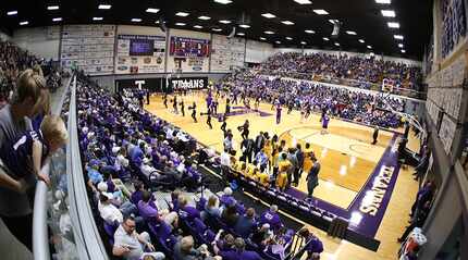 Fans look on during a basketball game at Tarleton State's Wisdom Gym.