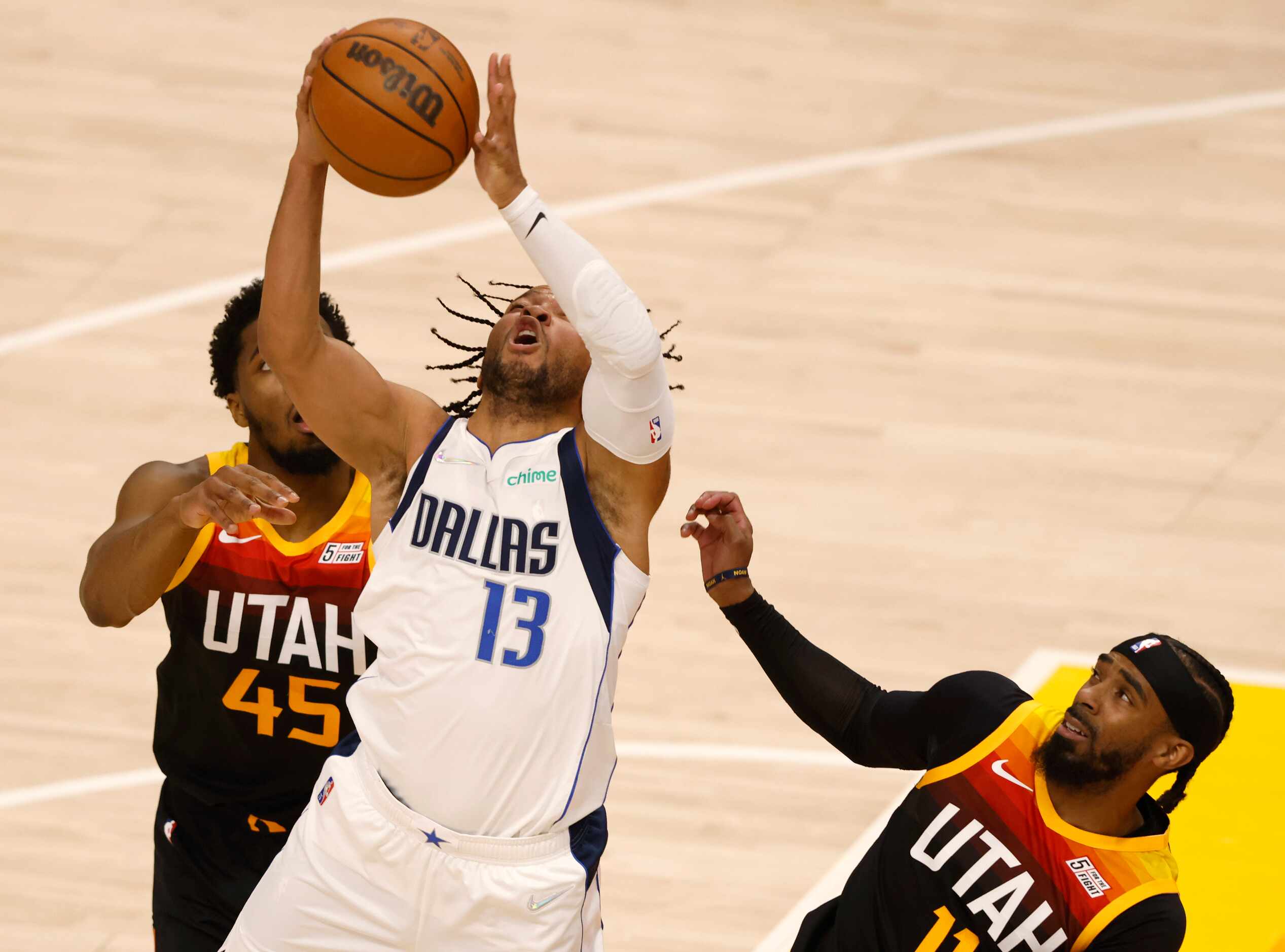 Dallas Mavericks guard Jalen Brunson (13) is fouled as he grabs a rebound in front of Utah...