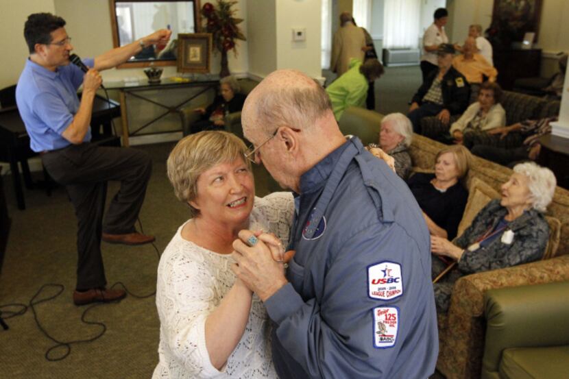 Beverly Brennan and Bill Null dance to the music sung by Marty Ruiz during a music therapy...