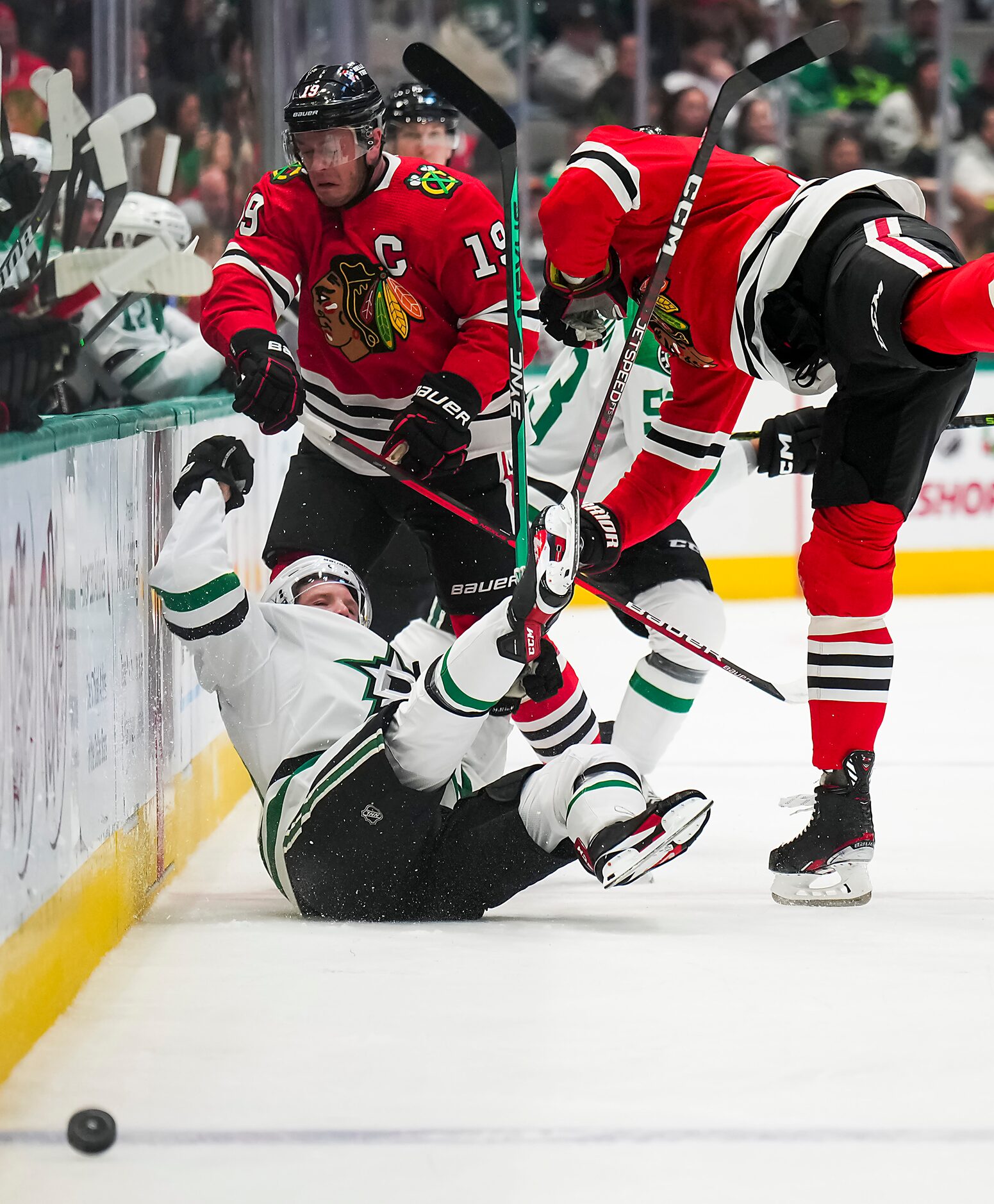 Dallas Stars center Ty Dellandrea (10) is knocked to the ice by Chicago Blackhawks...