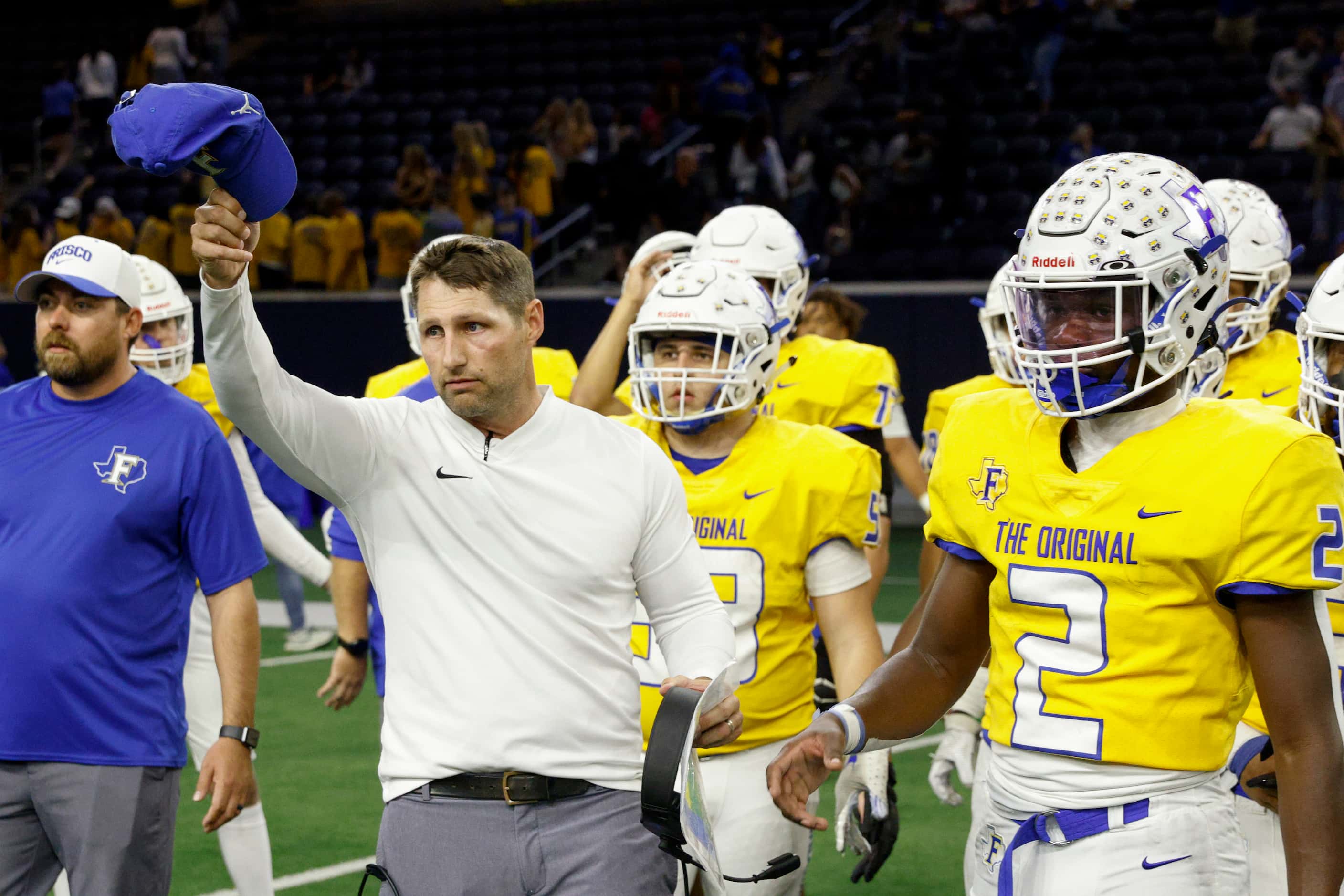 Frisco head coach Jeff Harbert tips his hat alongside wide receiver Ismael Taylor (2) after...