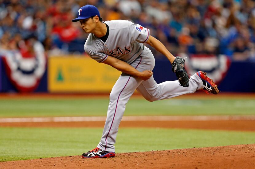 Texas Rangers starting pitcher Yu Darvish throws during the third inning of a baseball game...