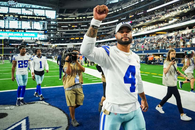 Dallas Cowboys quarterback Dak Prescott gestures to the crowd after an NFL preseason...