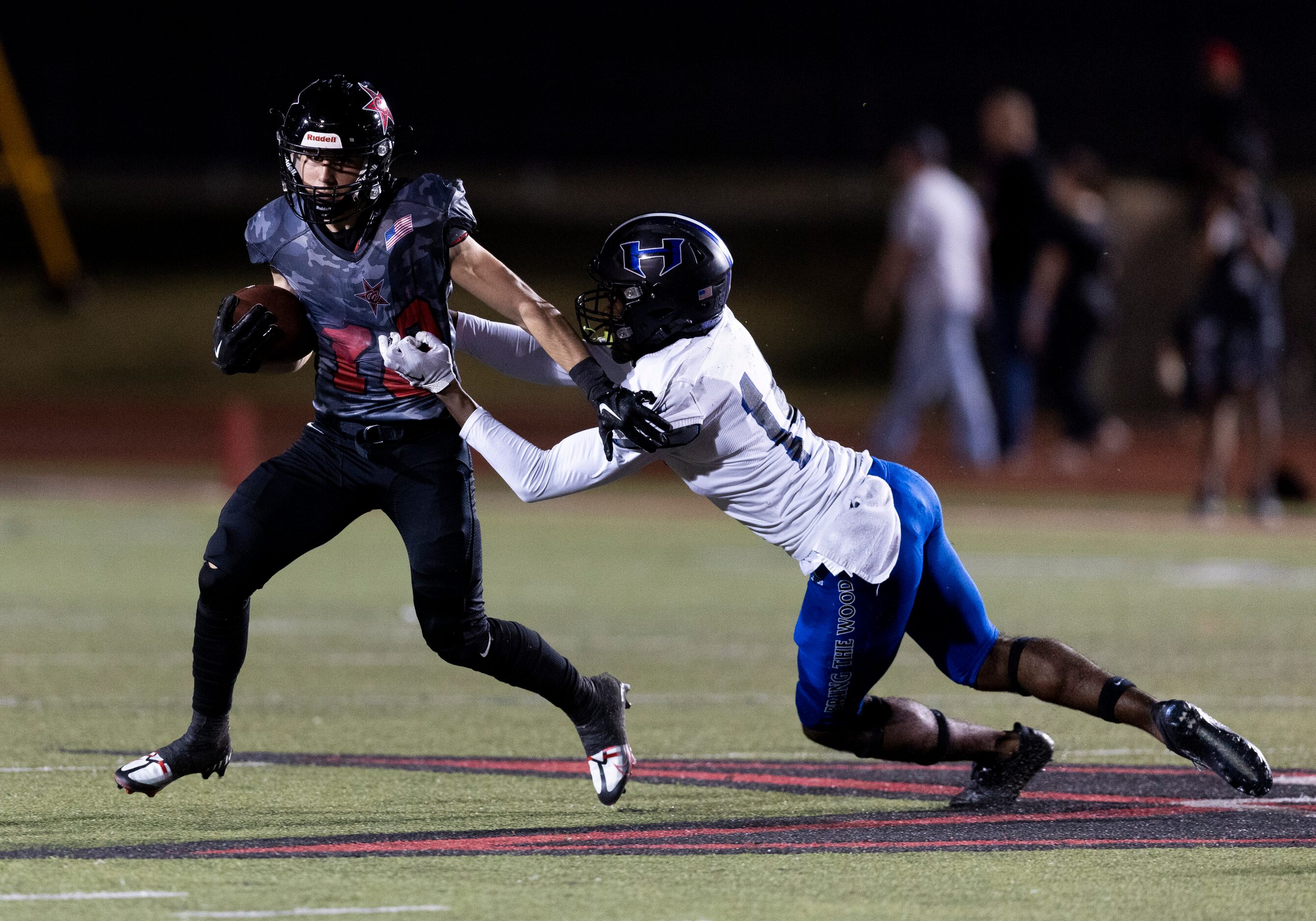 Coppell senior wide receiver Zack Darkoch (18) evades a tackle by Hebron sophomore defensive...