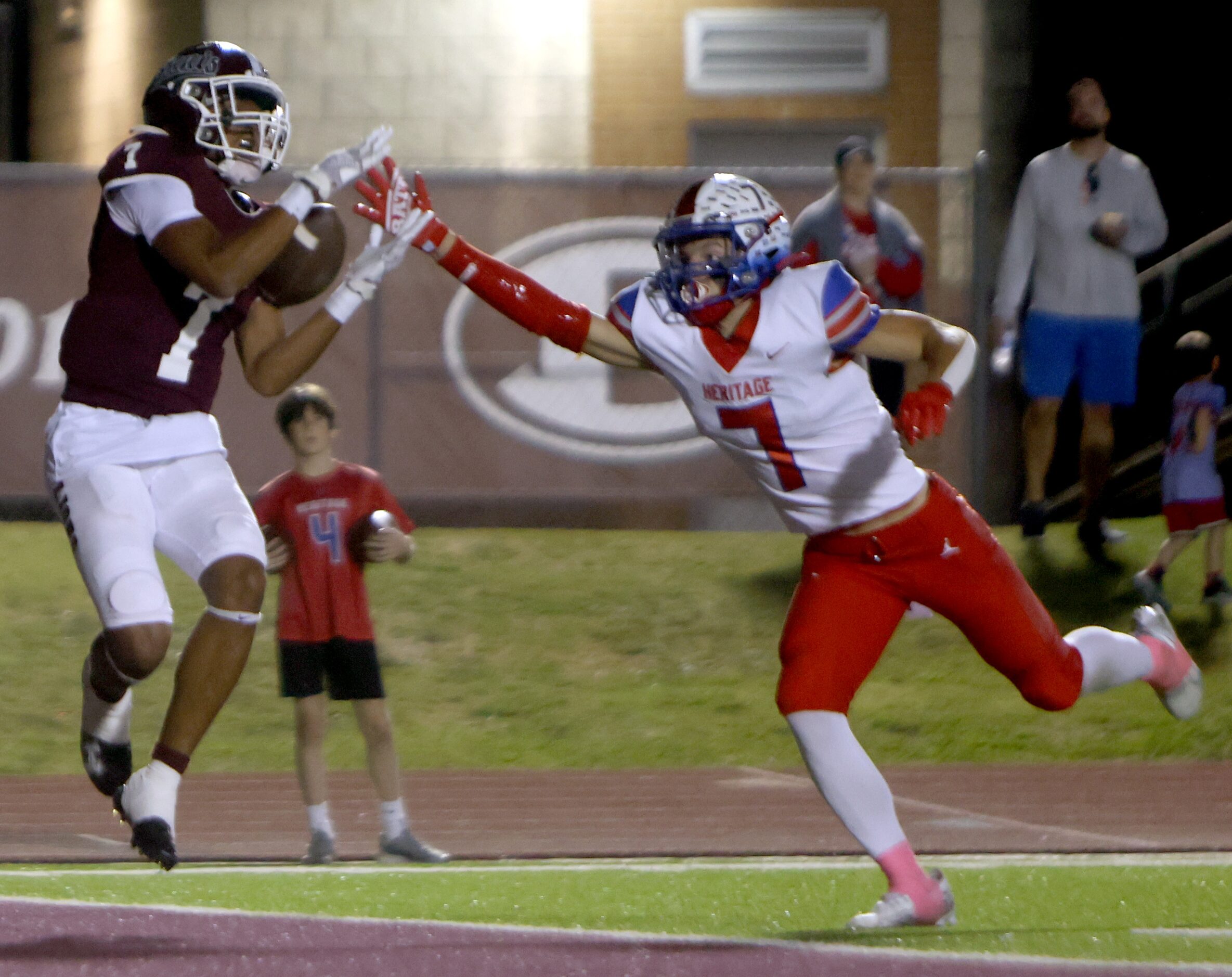 Ennis receiver Wondame Davis Jr. (7), left, pulls in a touchdown pass against the defense of...