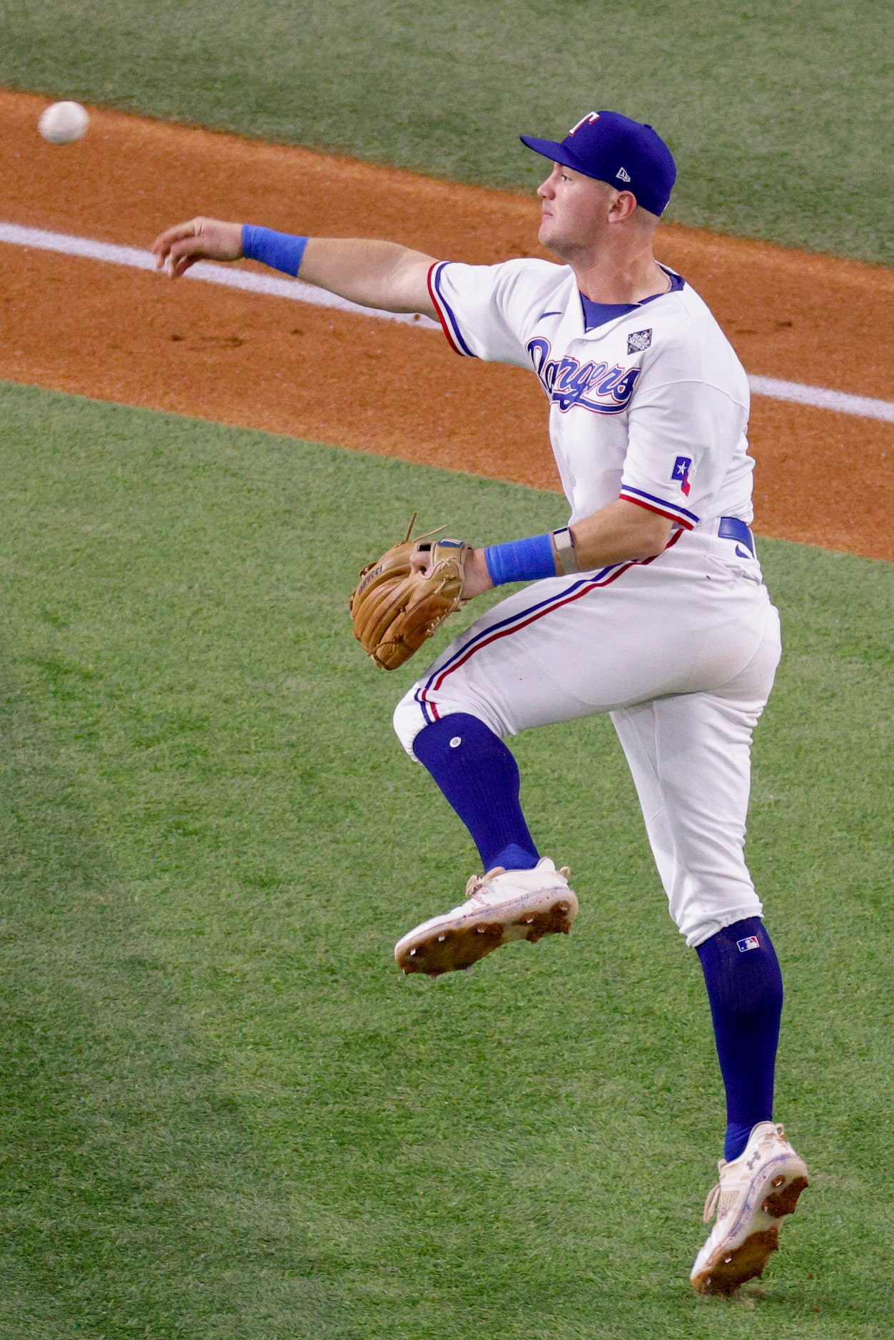 Texas Rangers third baseman Josh Jung (6) makes a late throw to first base as Arizona...