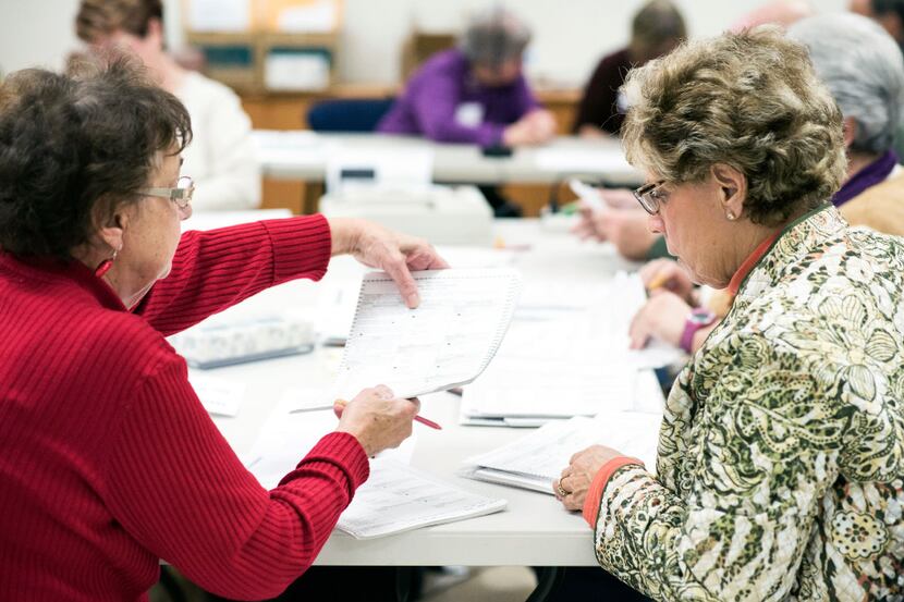 Ballots are checked during a recount of the presidential election at the Walworth County...
