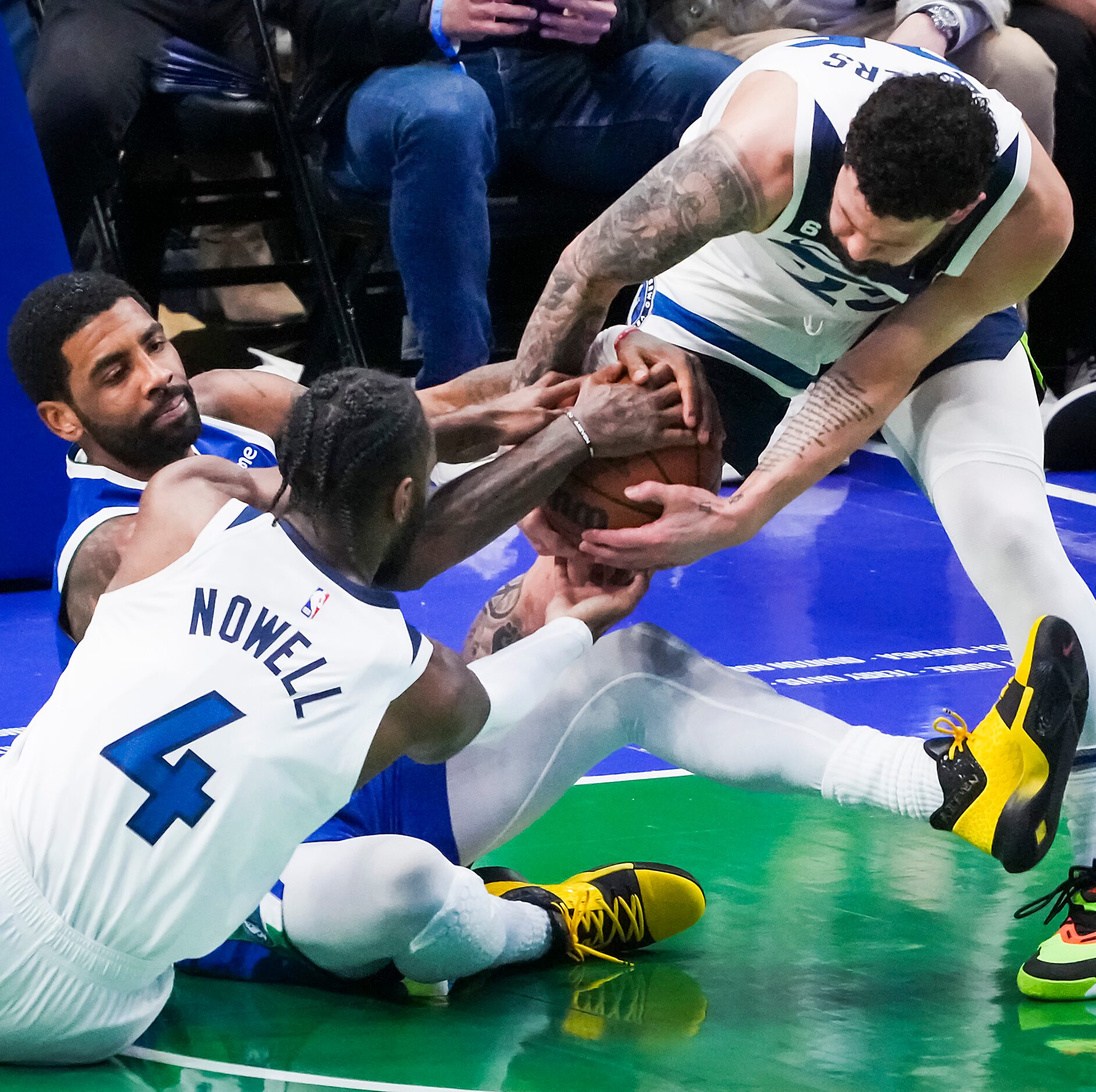 Dallas Mavericks guard Kyrie Irving (2) wrestles for a loose ball against Minnesota...