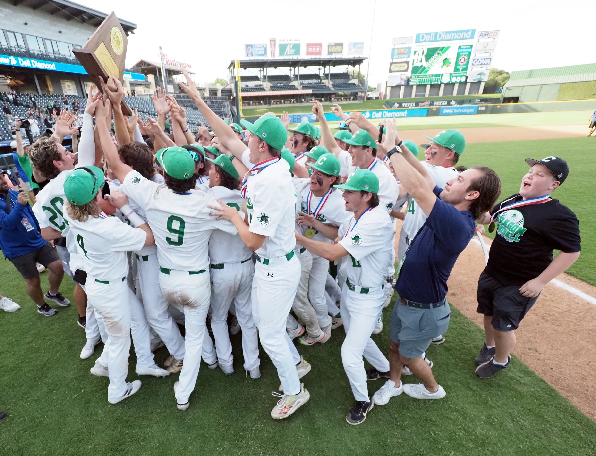 Southlake Carroll players life the first place trophy after defeating San Antonio Reagan in...